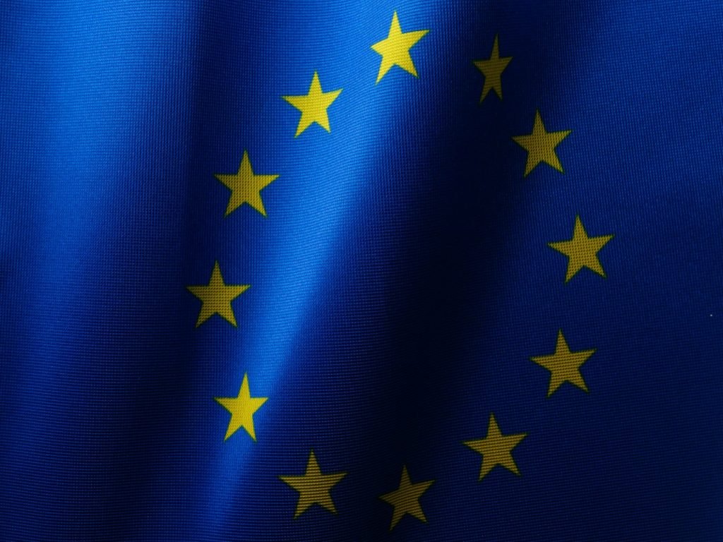 Flag of the EU as the European Commission has seen a flood of interest from companies looking to help create AI Gigafactories across Europe develop and train the next generation of artificial intelligence systems.