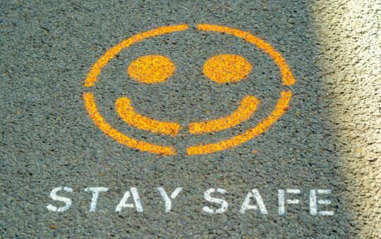 Stay safe written on the floor as Anthropic has detailed its safety strategy to try and keep its popular AI model, Claude, helpful while avoiding perpetuating harms.